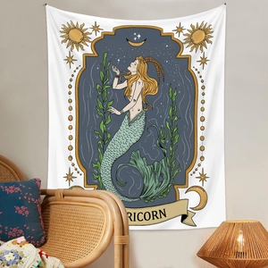 Detail of Capricorn zodiac tapestry with mythical sea-goat design in a cozy room setting