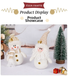 Close-up of festive plush gnome and snowman figures with gold knit hats for Christmas decor