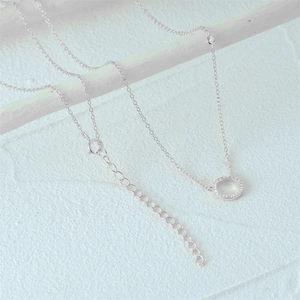 Macro view of S925 sterling silver necklace showing the pavé circle pendant and lobster clasp