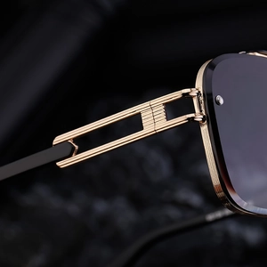 Detail of gold hollow metal temples and rivet hinge on luxury rimless sunglasses