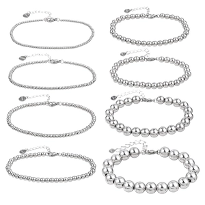 Set of 8 stainless steel beaded bracelets for men in varying bead sizes on white background