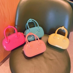 Detailed macro view of vibrant mini PVC jelly bags in multiple candy colors on a vintage chair