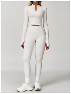 Close-up of cream white high-waist yoga pants and thumbhole zip jacket sportswear set