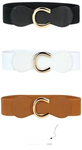 Detailed view of elastic waist belts in black, white and brown with golden C-buckles