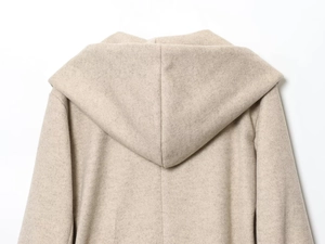 Detail view of the oatmeal hooded wool coat showing premium back stitching and hood texture