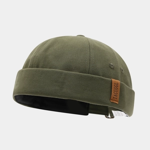 Army green canvas miki hat with adjustable strap and leather label in minimalist style