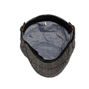 British style grey herringbone wool newsboy cap with blue polka dot lining and metal buckle