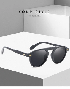 Detail of black vintage sunglasses with gold rivets on a white geometric background