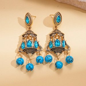 Vintage boho drop earrings with blue teardrop stones and turquoise beads in antique gold