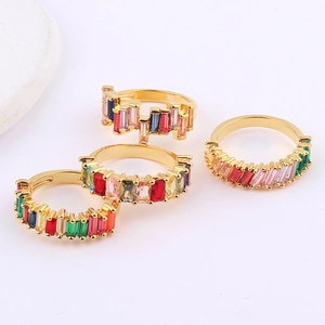 Set of four gold-plated rings with rainbow-colored rectangular zircons in a stackable design
