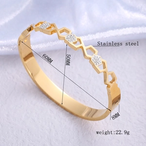 Golden stainless steel hexagonal hollow bangle with zircon crystals in main product view