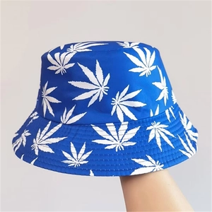 Detail of blue reversible bucket hat featuring white leaf patterns and cotton canvas texture