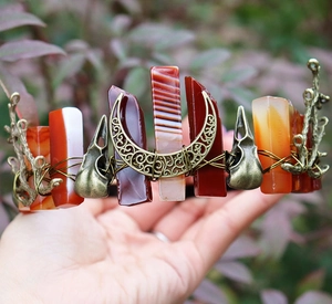 Detail of vintage bronze wire crown with red agate crystals and raven skull charms