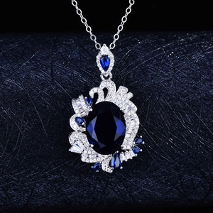 Royal blue oval gemstone pendant necklace with brilliant sapphire accents in silver