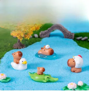 Close-up of cute capybara mini figurines with ducks in a creative micro landscape