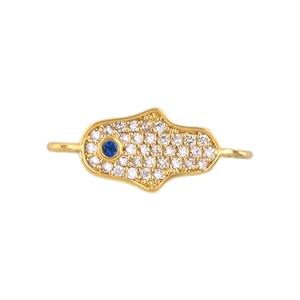 Macro view of gold Hamsa hand pendant with blue stone and pavé white zircon details