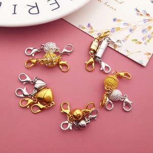 Close-up of heart and cylindrical magnetic jewelry clasps in gold and silver finish