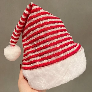 Festive red and white striped Christmas hat with shimmering sequins and plush pom-poms