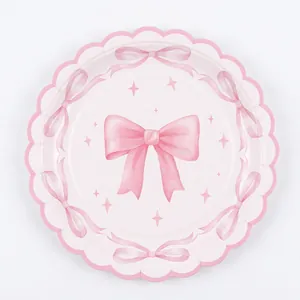 Pink bow party paper plate with scalloped edges and delicate ribbon star pattern