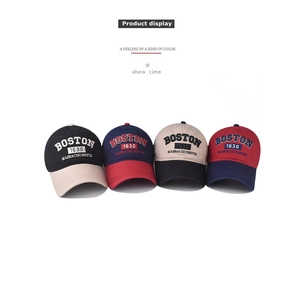 Detailed view of cotton baseball caps with Boston embroidery in four color combinations