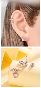 Macro shot of pink heart-shaped crystal stud earring on ear and geometric display