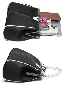 Detail view of the black pearl handle bag showing spacious interior for essentials