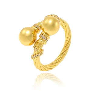 Detail of twisted gold open ring featuring large beads and sparkling zircon accents