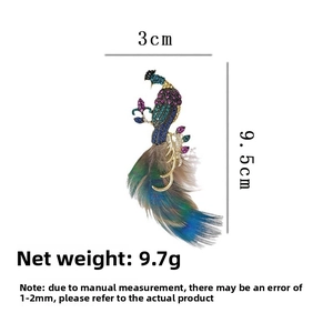 Detailed view of peacock feather brooch with crystals and 9.5cm length dimensions