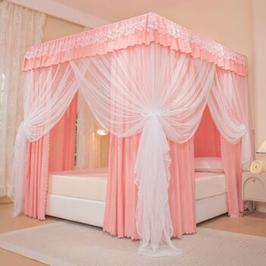 Detail of pink and white double-layer taffeta blanket on a cozy bed with soft netting