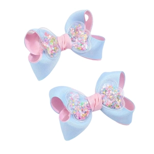 Pink and blue ribbon hair bows with quicksand heart sequin centers for girls