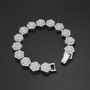 Macro shot of silver hip hop bracelet with crystal-paved hexagonal links and folding clasp