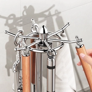 Rotating stainless steel kitchen utensil rack with wooden handles and hanging tools