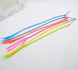 Macro detail of six colorful braided hair extensions with pins for kids' hairstyles
