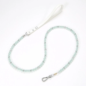 Close-up of mint green and pearl pet leash with white leather handle and silver hook