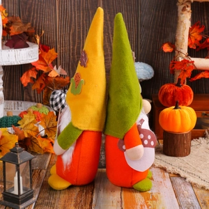 Fall themed Christmas gnomes with yellow and green hats on rustic wooden background