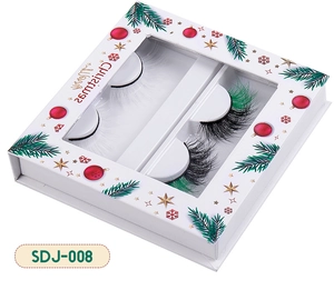 Detail of Christmas style false eyelashes set with white and green accented mink fur lashes