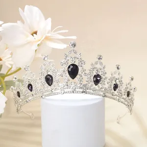 Detail of luxury crown featuring purple teardrop gemstones and crystal rhinestones