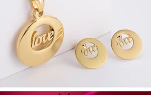 Macro view of gold plated titanium steel jewelry set featuring hollow LOVE circular pendant