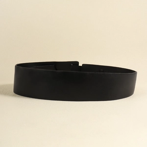 Detailed view of black wide PU leather belt with smooth texture for dresses and coats
