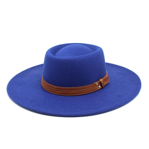 Detail of royal blue wool fedora with brown leather band and metal rivet accents