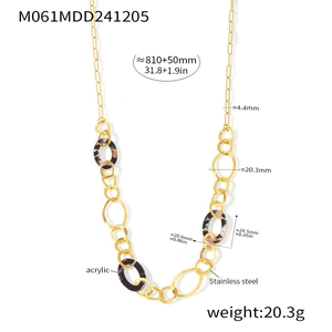 Detail view of leopard print acrylic ring necklace with stainless steel gold chain