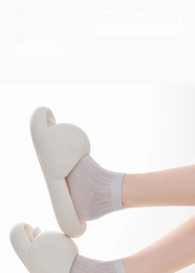 Close-up of white mesh silk socks with breathable texture and comfy thick-soled sandals