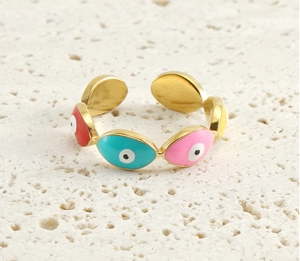 Macro shot of 18k gold-plated evil eye ring with colorful enamel detailing on stone