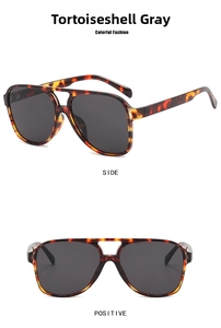 Detail view of tortoiseshell aviator sunglasses with double bridge and grey lenses
