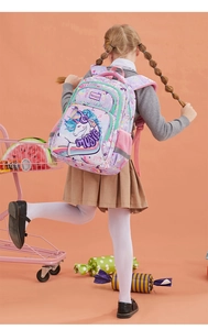 Girl wearing purple unicorn backpack with multi-layer zippers and padded straps