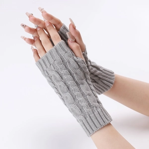 Detailed close-up of light grey cable knit arm warmers with fingerless design and wrist support