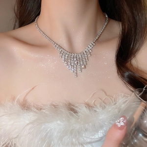 Close-up of silver zircon square tassel necklace on model with luxury sparkling details