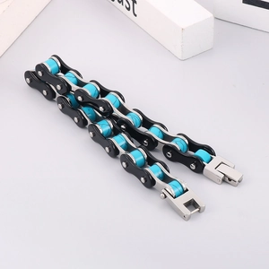 Detail of bike chain bracelet with blue beads and double-row metal links in black and silver
