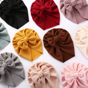 Detailed view of baby bow turban hats in multiple colors with waffle knit texture