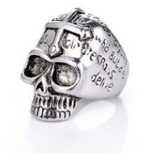 Detailed view of punk skull ring with cross top and engraved silver texture
